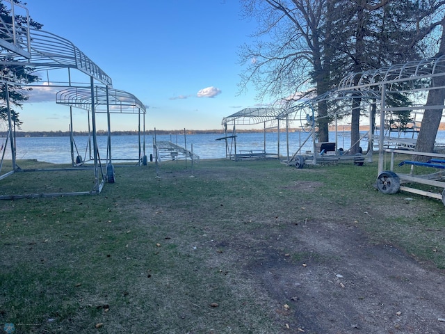 view of yard featuring a boat dock and a water view