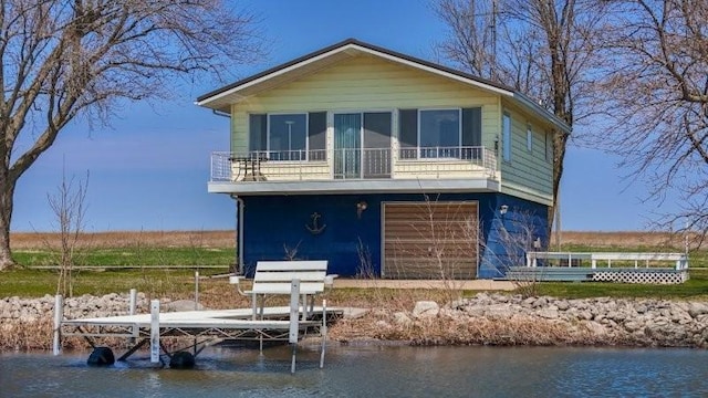 rear view of house featuring a sunroom and a water view
