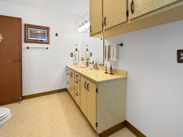 bathroom with vanity and baseboards