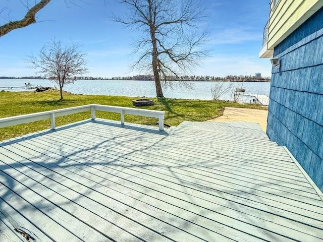 deck with a lawn and a water view