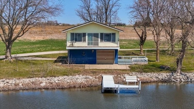 rear view of property featuring a sunroom and a water view