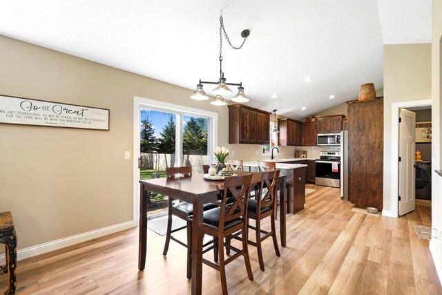 dining room featuring baseboards, vaulted ceiling, recessed lighting, and light wood-style flooring
