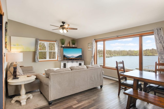 living area featuring a baseboard radiator, lofted ceiling, wood finished floors, and a ceiling fan
