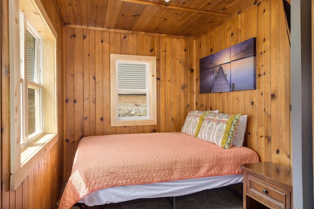 bedroom featuring wood ceiling and wooden walls