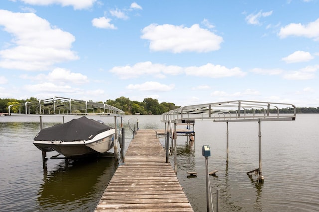 dock area with a water view and boat lift