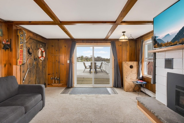 carpeted living area featuring a tile fireplace, wood walls, coffered ceiling, visible vents, and beamed ceiling