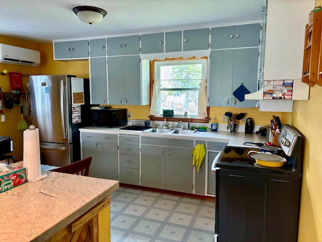kitchen featuring freestanding refrigerator, light floors, an AC wall unit, light countertops, and electric stove