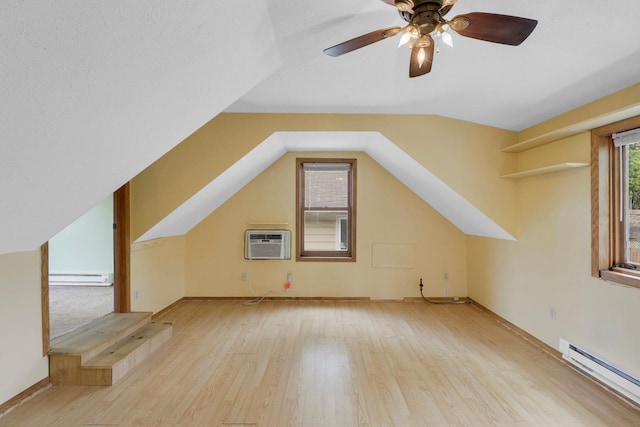 451 Taylor St NE, Minneapolis, MN 55413 - additional living space featuring a baseboard radiator, wood finished floors, a wall unit AC, ceiling fan, and vaulted ceiling