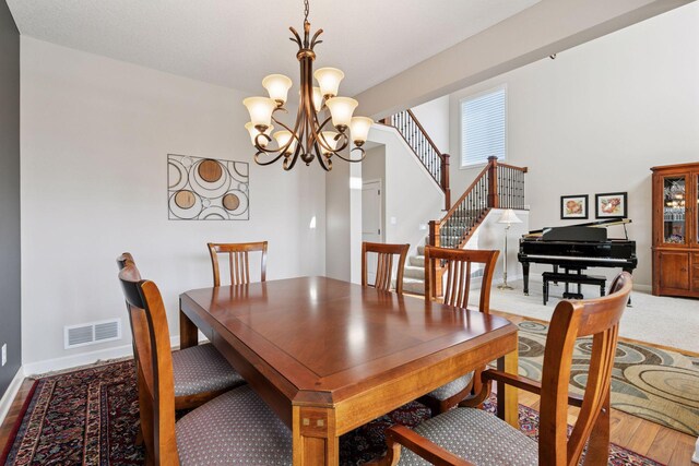 3626 Springwood Ct, Eagan, MN 55123 - dining room with a chandelier, baseboards, and stairs