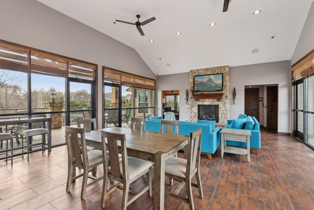3626 Springwood Ct, Eagan, MN 55123 - dining room featuring a ceiling fan, a stone fireplace, healthy amount of natural light, recessed lighting, and high vaulted ceiling