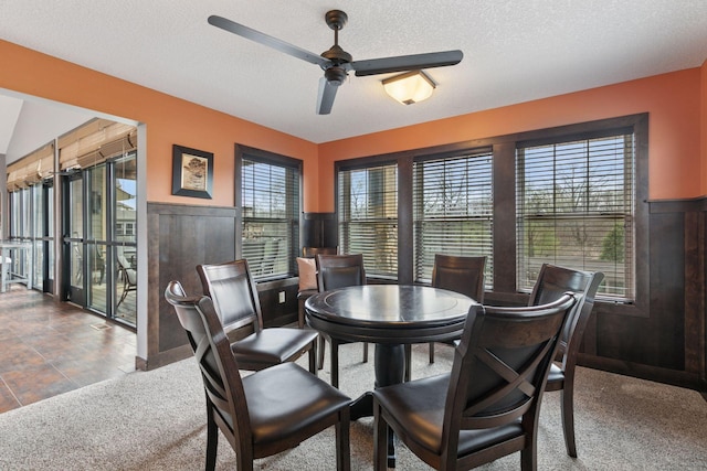 3626 Springwood Ct, Eagan, MN 55123 - carpeted dining room featuring a ceiling fan, a wainscoted wall, and a textured ceiling