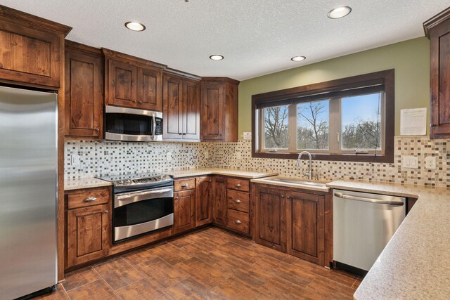 3626 Springwood Ct, Eagan, MN 55123 - kitchen with stainless steel appliances, a sink, decorative backsplash, recessed lighting, and dark wood finished floors