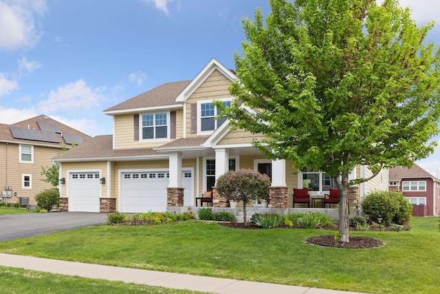 3626 Springwood Ct, Eagan, MN 55123 - craftsman-style home with a porch, asphalt driveway, stone siding, and a front yard