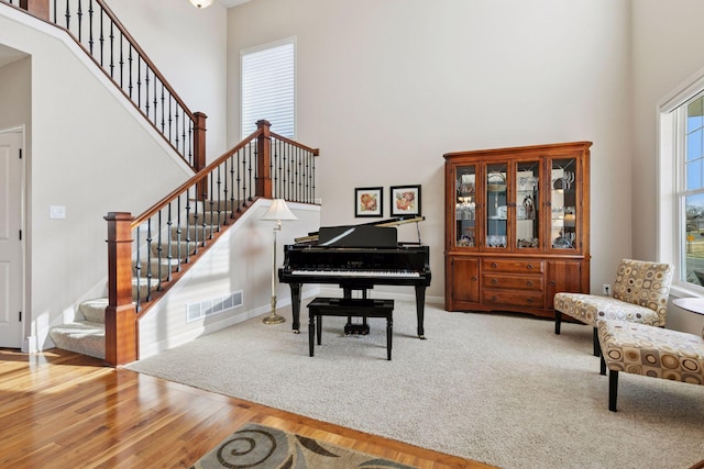 3626 Springwood Ct, Eagan, MN 55123 - living area featuring a towering ceiling, stairs, wood finished floors, and baseboards