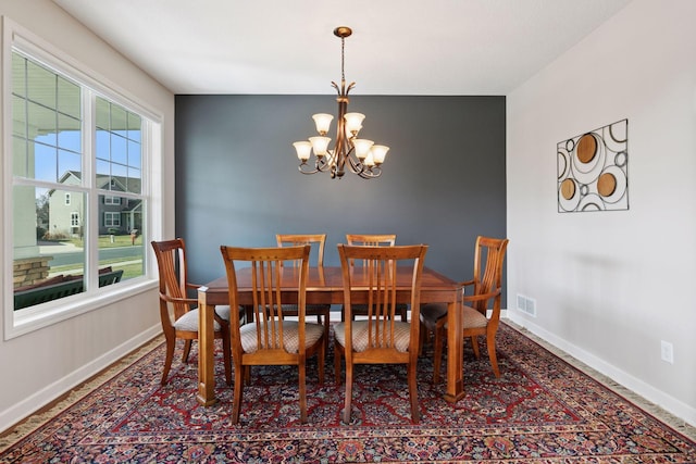 3626 Springwood Ct, Eagan, MN 55123 - dining area with baseboards, a chandelier, and an accent wall