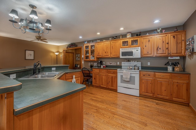 2475 44th St SW, Pine River, MN 56474 - kitchen featuring dark countertops, a sink, brown cabinetry, and white appliances