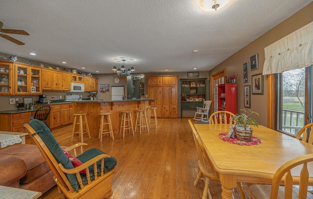 2475 44th St SW, Pine River, MN 56474 - dining room with recessed lighting, ceiling fan with notable chandelier, a textured ceiling, and light wood finished floors
