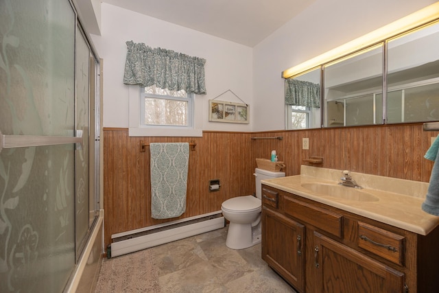 2475 44th St SW, Pine River, MN 56474 - bathroom with toilet, a wainscoted wall, baseboard heating, and a wealth of natural light