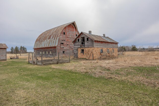 2475 44th St SW, Pine River, MN 56474 - view of property exterior featuring an outdoor structure, a barn, metal roof, a yard, and a gambrel roof