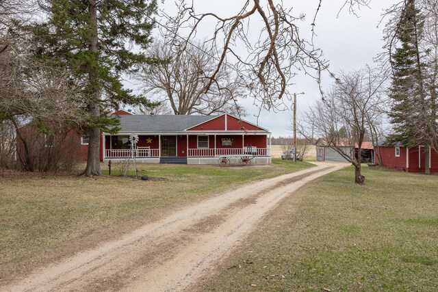 2475 44th St SW, Pine River, MN 56474 - view of front of house with a porch, a front lawn, a shingled roof, an outbuilding, and driveway