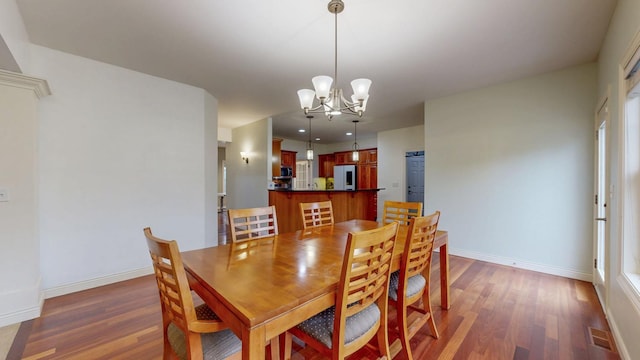 1213 Grey Fox Ave SW, Rochester, MN 55902 - dining area with wood finished floors, a chandelier, baseboards, and recessed lighting