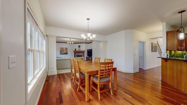1213 Grey Fox Ave SW, Rochester, MN 55902 - dining room with a chandelier, wood finished floors, and baseboards