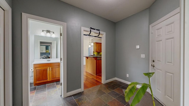 1213 Grey Fox Ave SW, Rochester, MN 55902 - hallway featuring baseboards and stone tile floors