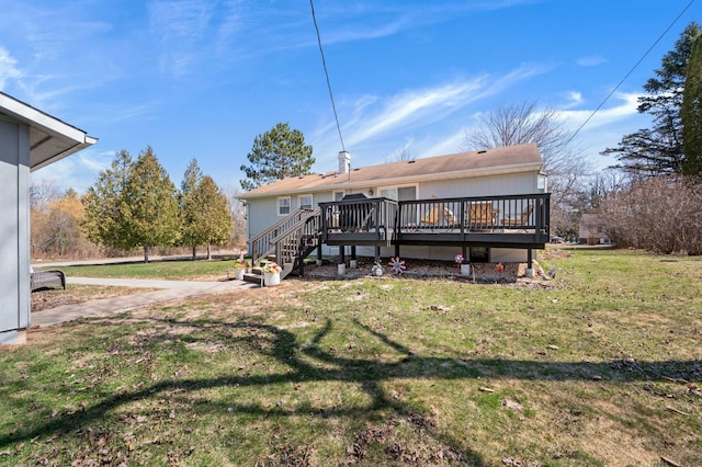 1601 5th Ave, Grand Rapids, MN 55744 - rear view of house featuring a lawn and a wooden deck