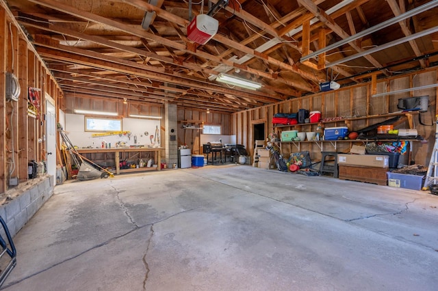 1601 5th Ave, Grand Rapids, MN 55744 - garage featuring a workshop area and a garage door opener