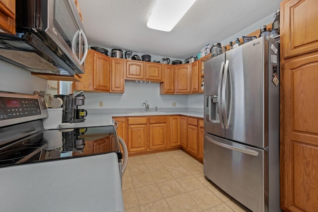 1601 5th Ave, Grand Rapids, MN 55744 - kitchen featuring a textured ceiling, a sink, appliances with stainless steel finishes, and light countertops