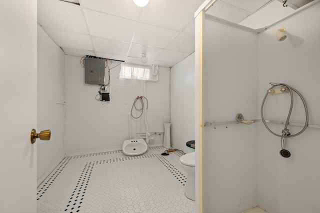 1601 5th Ave, Grand Rapids, MN 55744 - bathroom featuring toilet, a stall shower, a paneled ceiling, and electric panel