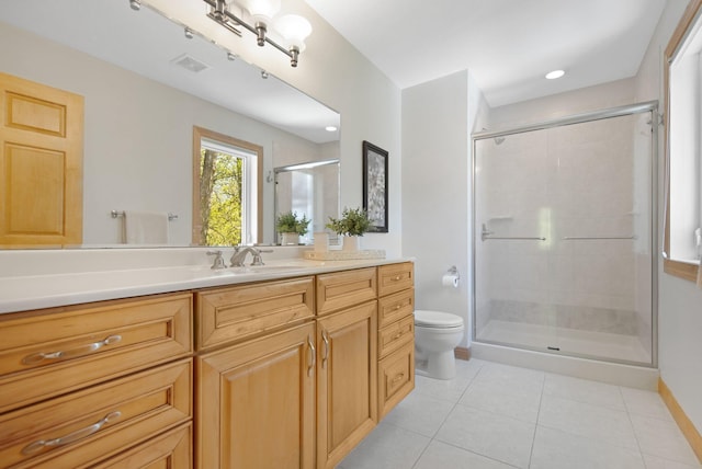 bathroom featuring tile patterned flooring, a shower stall, toilet, vanity, and baseboards