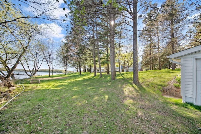 view of grassy yard with a water view