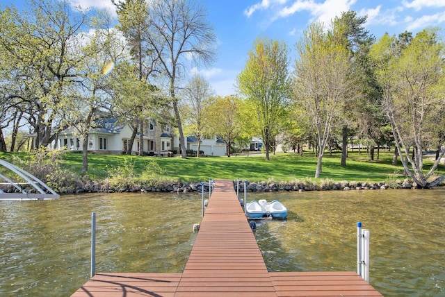 dock featuring a water view and a yard