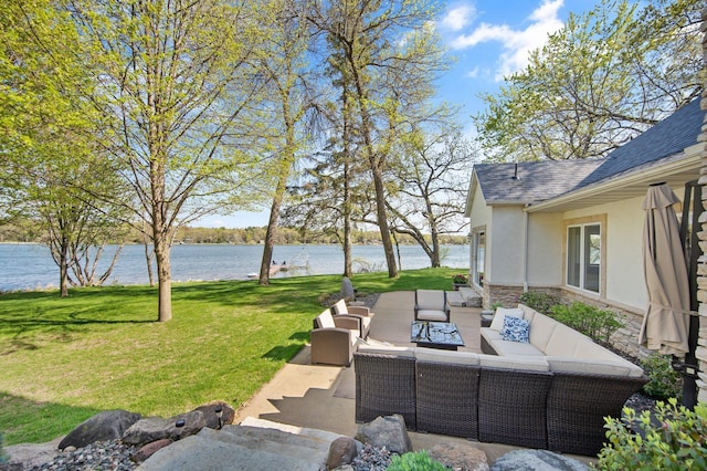view of grassy yard with outdoor lounge area, a water view, and a patio area
