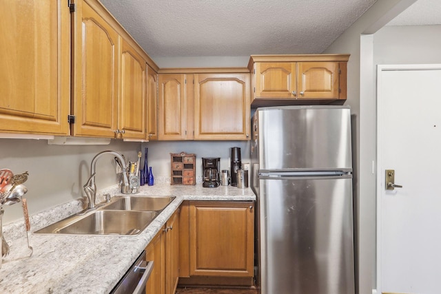 1425 28th St Unit 407, Minneapolis, MN 55408 - kitchen with appliances with stainless steel finishes, a sink, light countertops, and a textured ceiling
