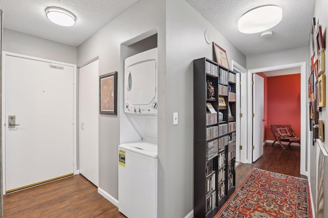 1425 28th St Unit 407, Minneapolis, MN 55408 - washroom with stacked washer / drying machine, a textured ceiling, dark wood-style floors, and baseboards
