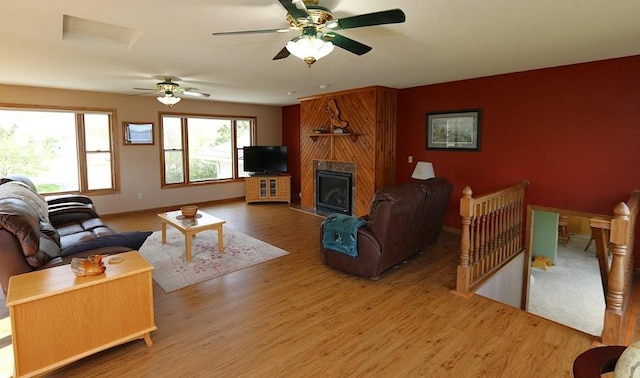 44172 Mosquito Heights Rd, Perham, MN 56573 - living area with wood finished floors, a ceiling fan, a fireplace, and baseboards