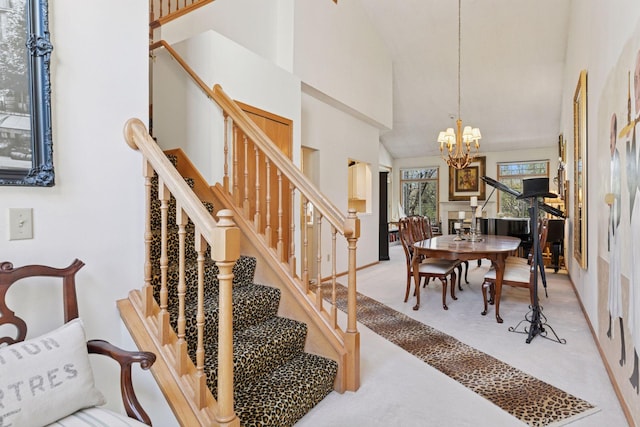 2499 Lockwood Dr Unit 61, Mendota Heights, MN 55120 - carpeted dining area featuring a chandelier, stairs, and high vaulted ceiling