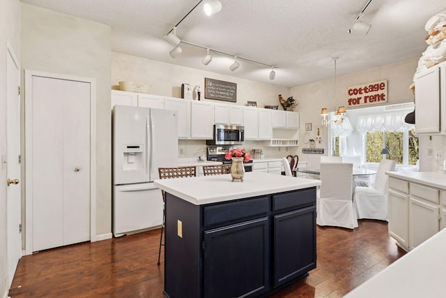2499 Lockwood Dr Unit 61, Mendota Heights, MN 55120 - kitchen with appliances with stainless steel finishes, track lighting, dark wood-style flooring, and white cabinetry