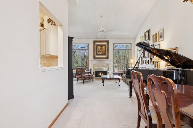 2499 Lockwood Dr Unit 61, Mendota Heights, MN 55120 - sitting room featuring plenty of natural light, a ceiling fan, light colored carpet, a glass covered fireplace, and lofted ceiling
