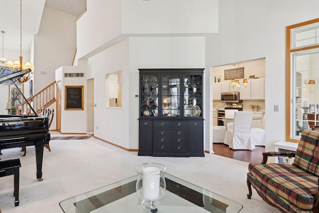 2499 Lockwood Dr Unit 61, Mendota Heights, MN 55120 - carpeted living room featuring a high ceiling, a chandelier, and stairway