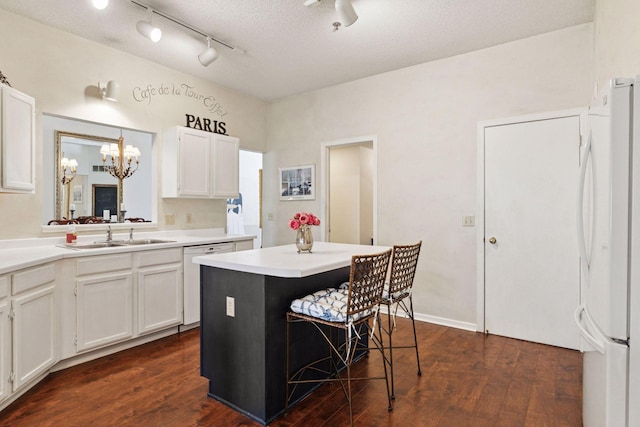 2499 Lockwood Dr Unit 61, Mendota Heights, MN 55120 - kitchen featuring freestanding refrigerator, dishwashing machine, a chandelier, white cabinets, and a kitchen island