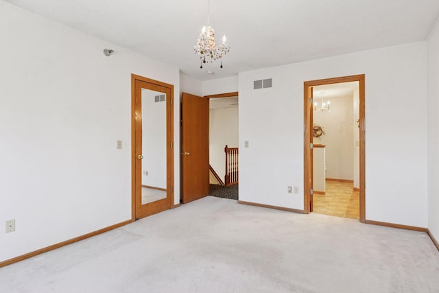 2499 Lockwood Dr Unit 61, Mendota Heights, MN 55120 - unfurnished bedroom featuring a chandelier, carpet, and connected bathroom