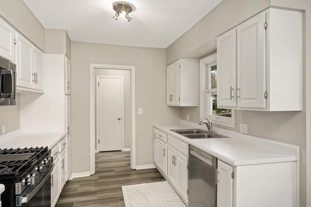 kitchen with a sink, dark wood-style floors, white cabinets, and stainless steel appliances