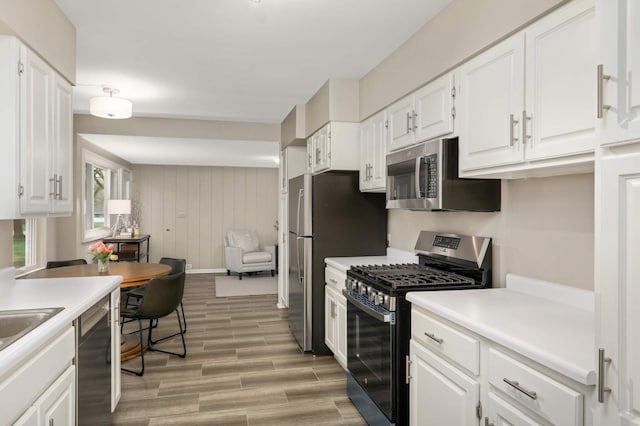 kitchen with light countertops, appliances with stainless steel finishes, and white cabinets