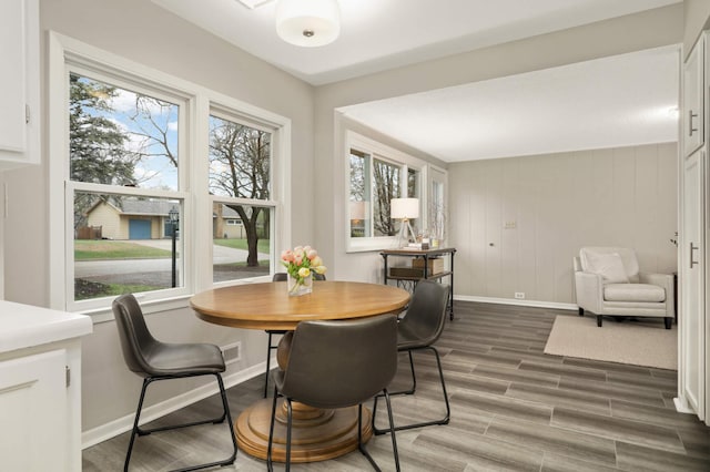 dining room featuring baseboards and wood finished floors