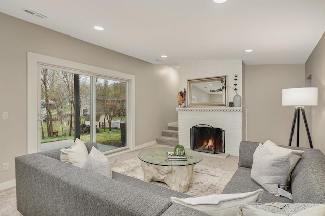 living area with visible vents, a brick fireplace, baseboards, recessed lighting, and carpet