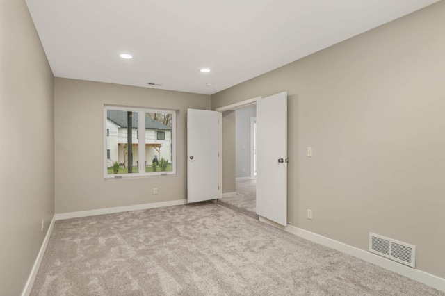 spare room with visible vents, recessed lighting, baseboards, and carpet floors
