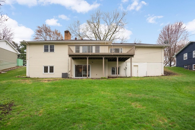 back of property featuring a lawn, a deck, a chimney, and central air condition unit
